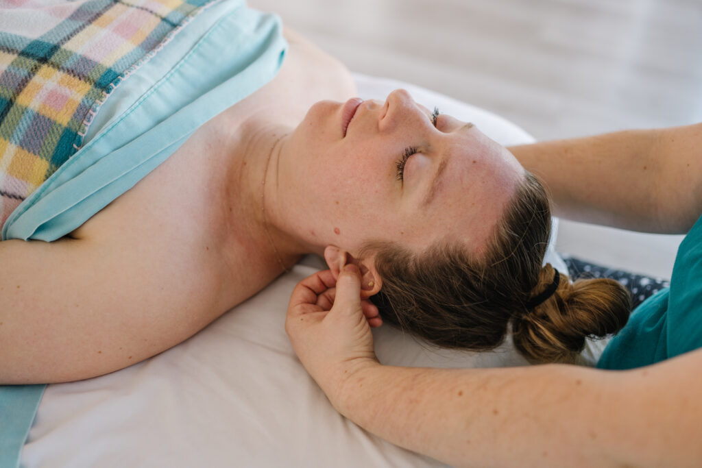 NewPerspective-121 a woman lying down on a bed with her eyes closed
